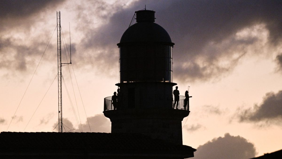 People stand on a balcony during a nationwide blackout in Havana on March 21, 2026. (AFP) People stand on a balcony during a nationwide blackout in Havana on March 21, 2026. (AFP)