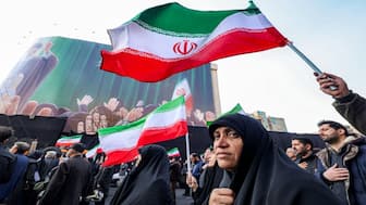Demonstrators gather with Iranian national flags for a rally in support of the new Supreme Leader at Enghelab Square in central Tehran. AFP