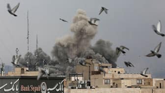 Birds fly as smoke rises following an explosion, after Israel and the US launched strikes on Iran, on March 2. Reuters
