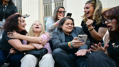 Parents and family members of victims celebrate to news that the jury has found Meta and YouTube liable in the social media addiction trial, outside the Los Angeles Superior Court , in Los Angeles. The jury found Meta and YouTube liable for harming a young woman through the addictive design of their social media platforms and ordered the companies to pay $3 million in damages. AFP