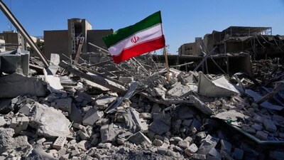An Iranian flag is placed among the ruins of a police station struck on Monday during the US-Israeli military campaign in Tehran, Iran. AP
