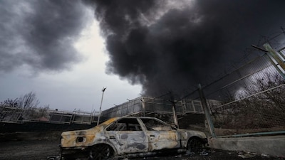 A thick plume of smoke rises from an oil storage facility hit by a US-Israeli strike late Saturday in Tehran, Iran. AP