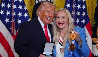 US President Donald Trump was presented  with the Order of Ikkos medal by Olympic bobsledder Kaillie Humphries. Image: AP 