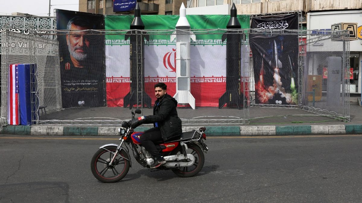 A motorist rides past the dummy models of Iranian missiles installed along the roadside at the Valiasr Square, in Tehran. The war is nearing the one-month mark, with no signs of it abating. AFP A motorist rides past the dummy models of Iranian missiles installed along the roadside at the Valiasr Square, in Tehran. The war is nearing the one-month mark, with no signs of it abating. AFP