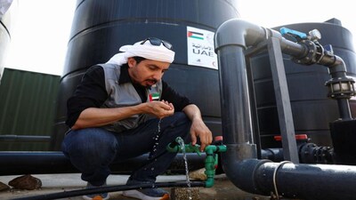 An Emirati man drinks from desalinated water at a UAE desalination plant. The Iran war is exposing another major resource vulnerability in West Asia -- drinking water. File image/Reuters