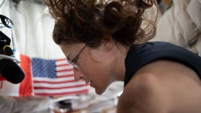 In this photo provided by Nasa, astronaut Christina Koch is pictured on the fourth day of the mission, prepping for lunar flyby activities after completing aerobic exercise on the flywheel device, during the The Artemis II crew's journey to the Moon,  April 4, 2026. Nasa via AP