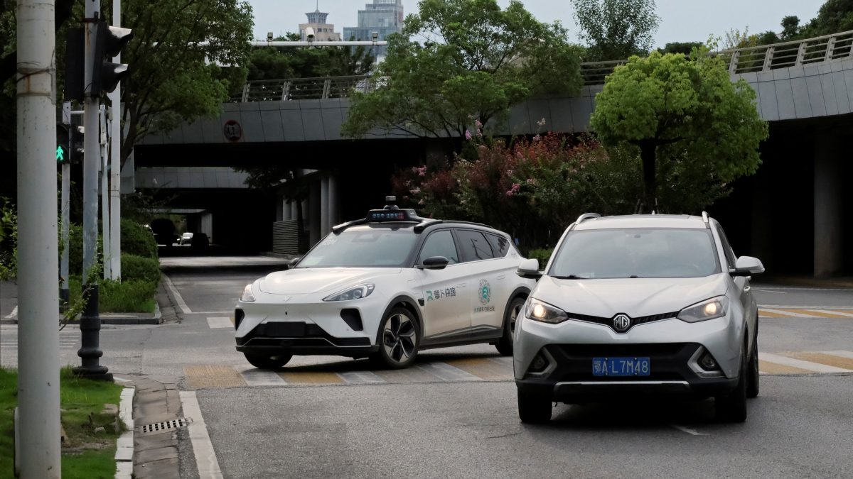 FILE PHOTO: A driverless car by Apollo Go, Baidu's robotaxi service, gives way to another car making a U-turn at a crossing in Wuhan, Hubei province, China July 19, 2024. REUTERS/Ethan Wang/File Photo FILE PHOTO: A driverless car by Apollo Go, Baidu's robotaxi service, gives way to another car making a U-turn at a crossing in Wuhan, Hubei province, China July 19, 2024. REUTERS/Ethan Wang/File Photo