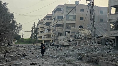 A man walks through the debris of destroyed buildings at the site of an Israeli airstrike in the Al Hosh area near the coastal Lebanese city of Tyre on April 4, 2026. AFP