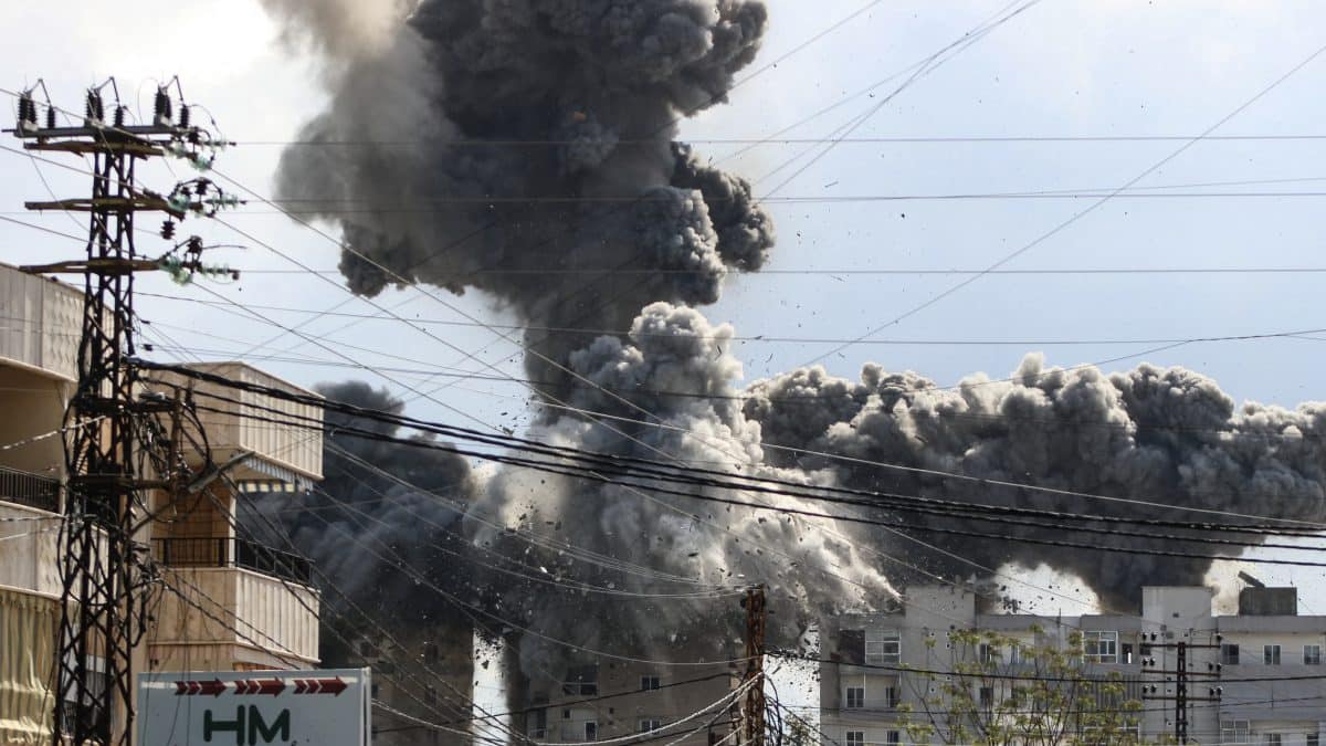Smoke and debris rise after a building is hit by an Israeli airstrike in the area of Abbasiyeh, on the outskirts of the southern Lebanese city of Tyre, on April 8, 2026. Lebanon's army warned people against returning to the country's south on April 8, where the Israeli military is still launching attacks, as Israel said the ceasefire with Iran did not include its conflict with Hezbollah. (Photo by Kawnat HAJU / AFP)