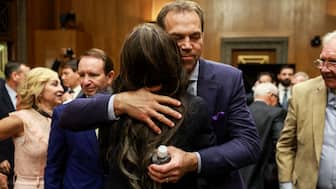 Kristi Noem, then US President-elect Donald Trump's secretary of Homeland Security nominee, hugs her husband Bryon Noem, on the day she testifies during a Senate Homeland Security and Governmental Affairs Committee confirmation hearing on Capitol Hill in Washington, US, January 17, 2025. File Image/Reuters