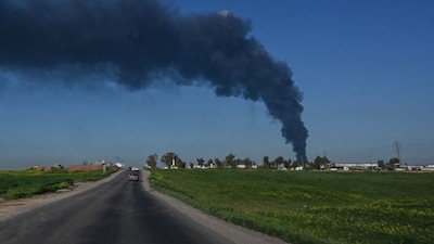 Smoke billows from an oil warehouse in the Kani Qirzhala area on the outskirts of Erbil, the capital of Iraq's autonomous Kurdistan region, following a suspected drone strike, on April 1, 2026.- AFP
