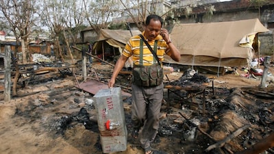 A policeman carries his colleague's belongings at a police camp that was attacked by Maoists in Silda village, about 200 km (125 miles) west of state capital Kolkata, February 16, 2010. File Photo/Reuters