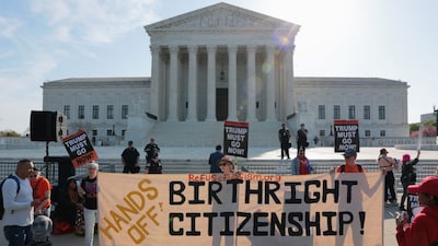 Demonstrators hold signs outside the US Supreme Court building on the day the court is expected to hear oral arguments on the legality of the Trump administration's effort to limit birthright citizenship for the children of immigrants, in Washington, DC, US, April 1, 2026. File Image/Reuters