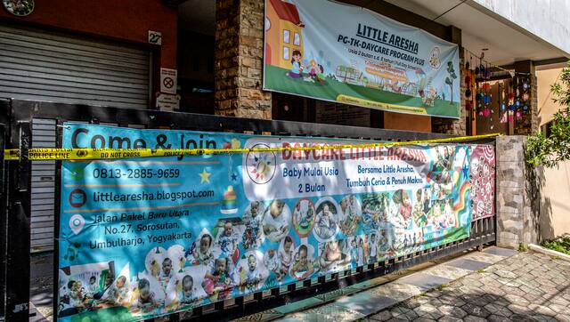 The gate of the Little Aresha daycare centre, sealed with police yellow tape. AFP