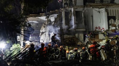 Israeli search and rescue personnel work at the site of a residential building destroyed in an Iranian strike in the northern city of Haifa on April 5, 2026. (AFP)
