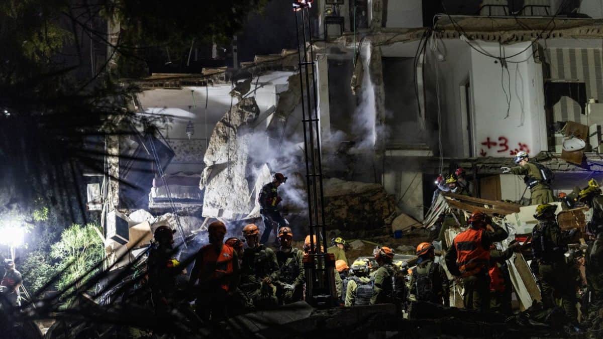 Israeli rescuers dig through rubble for missing after Iranian missile hits residential block