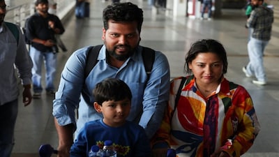 An Indian family who were stranded in Dubai arrives at the Indira Gandhi International Airport in New Delhi amid the Iran war. File image/Reuters