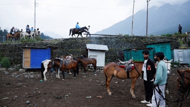 People offering pony rides, wait for tourists at a local pony stand in Pahalgam. Reuters
