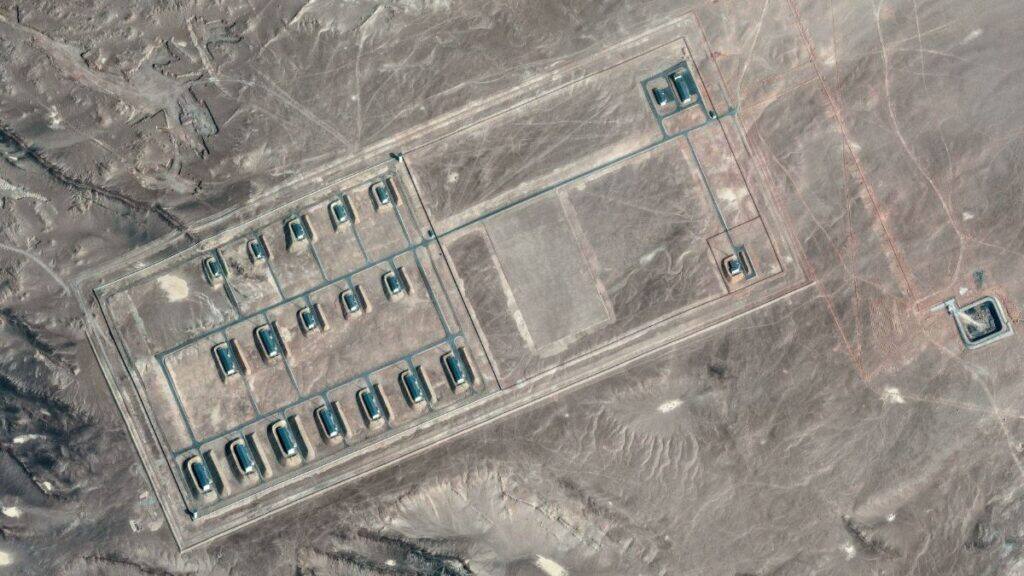 A satellite image shows what security analysts say is a fortified weapons storage installation, revealing revetments around the building, a perimeter wall and guard towers, in the Xinjiang Uyghur Autonomous Region, China, March 19, 2026. Image/Vantor via Reuters