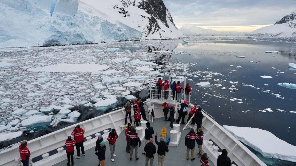Passengers watch as a ship sails through the Lemaire Channel in Antarctica, November 24, 2025. Representational Image/AP