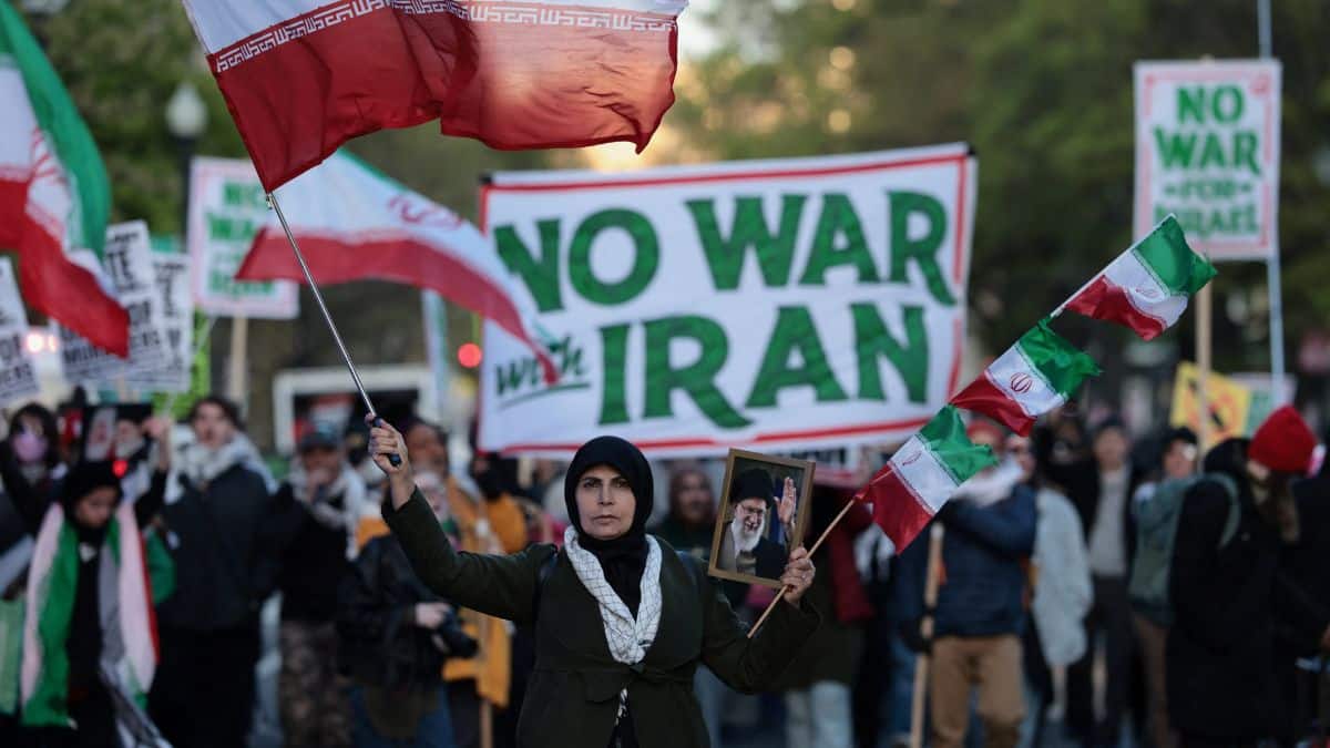 A demonstrator carries a portrait of the late Supreme Leader of Iran Ayatollah Ali Khamenei during a protest against military action in Iran near the White House in Washington. File/Reuters