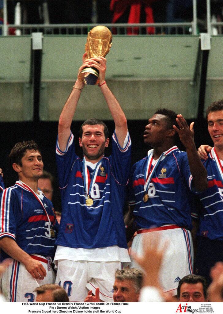 Football - 1998 FIFA World Cup - Final - France v Brazil - Stade de France, Saint Denis - France's 2 goal hero Zinedine Zidane holds aloft the World Cup. Image/Action Images Studio via Reuters