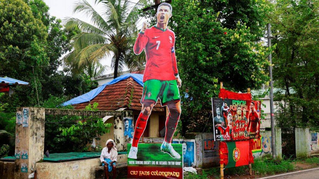 A man sits next to the cutout of Portugal's Cristiano Ronaldo ahead of the 2026 FIFA World Cup, in the outskirts of Kochi in Kerala, India June 10, 2026. File Image/Reuters