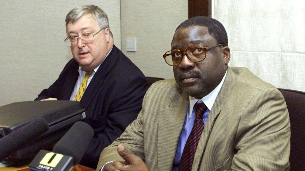 Francois Lumumba (R), the son of murdered former Congo Prime Minister Patrice Lumumba, sits next to his lawyer Bernard Remiche, before being heard in the Lumumba Commission in Brussels June 15, 2001. File Image/Reuters