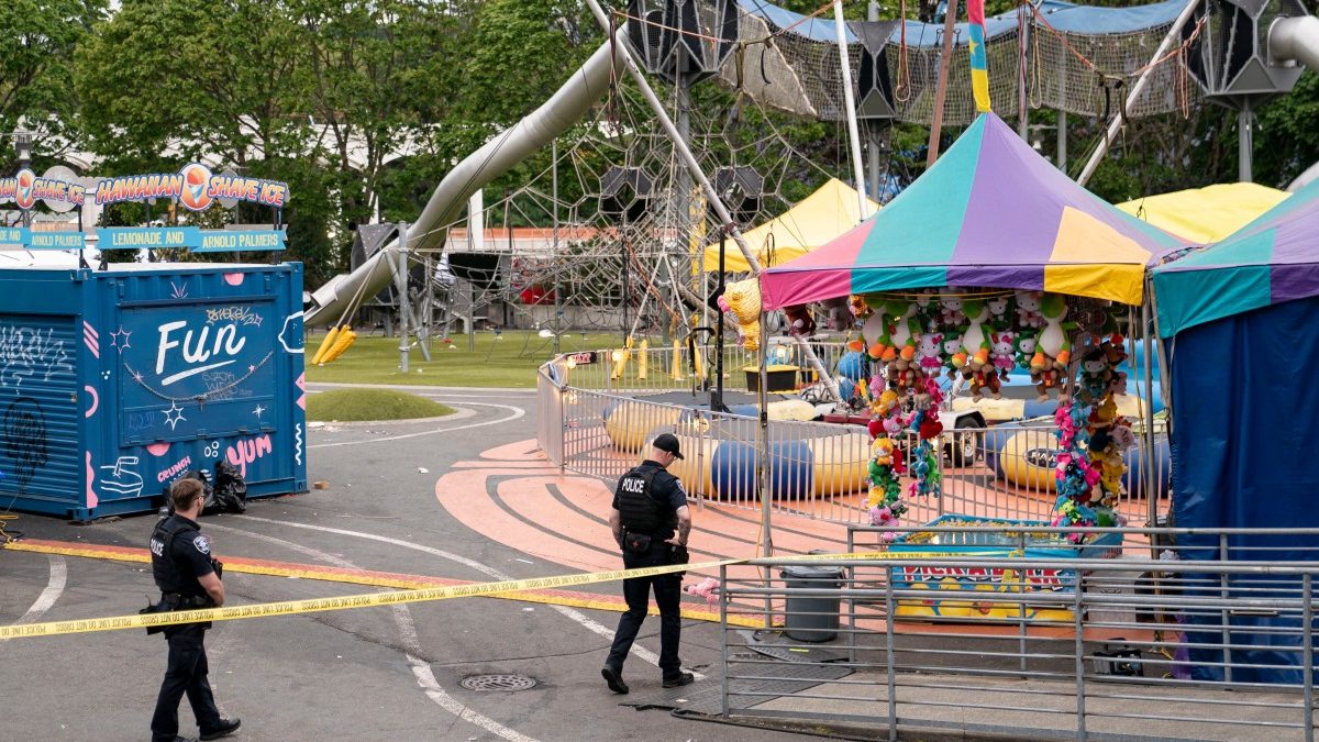 Photo: firstpost.com Police officers walk on patrol at the scene of a mass shooting at the Bite of Seattle food festival on July 26, 2026 in