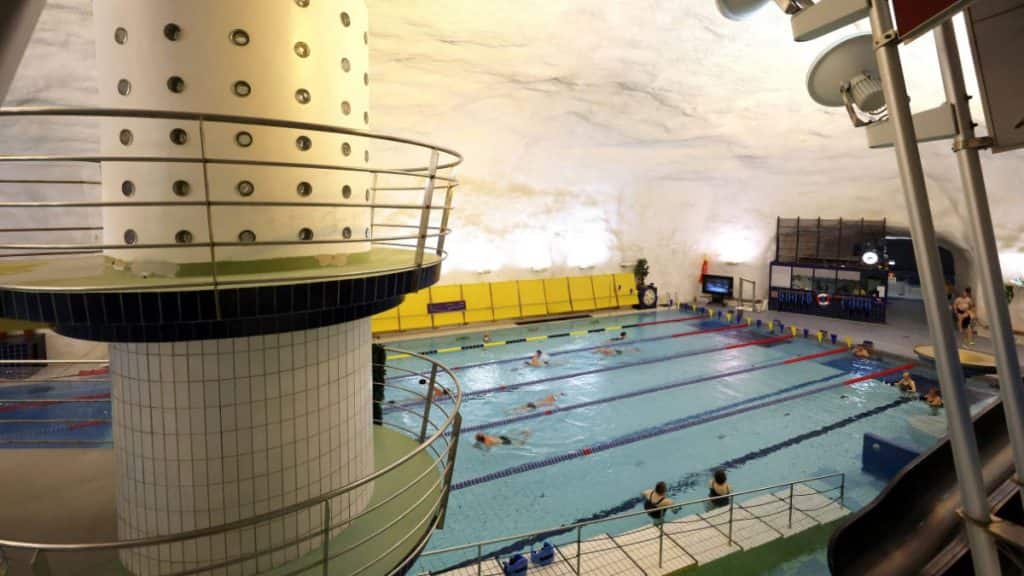 People swim in Itakeskus Swimming Hall, Helsinki's underground swimming pool carved into solid bedrock, which can be drained and converted into a bomb shelter for 3,800 people, in Helsinki, Finland, May 6, 2026. File Image/Reuters