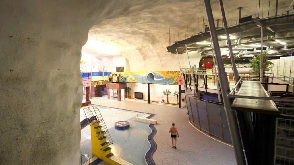 A man walks inside Itakeskus Swimming Hall, Helsinki's underground swimming pool carved into solid bedrock, which can be drained and converted into a bomb shelter for 3,800 people, in Helsinki, Finland, May 6, 2026. File Image/Reuters