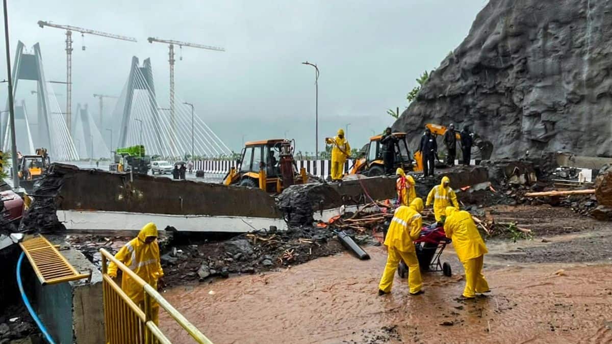 Rescue personnel carry out operations with the help of earthmovers after heavy rainfall triggered a landslide near the Missing Link section of the Pune-Mumbai Expressway, in Maharashtra. PTI