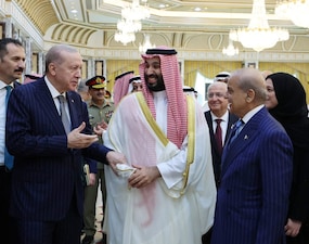 Turkish President Tayyip Erdogan, Saudi Crown Prince Mohammed bin Salman and Pakistan's Prime Minister Shehbaz Sharif chat after signing a joint defence agreement in Mecca, Saudi Arabia, on August 7. Turkish Presidential Press Office/Handout via Reuters