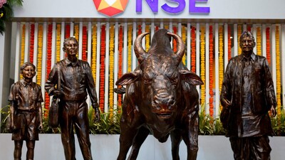 Statues of people and a bull are seen next to the logo of the National Stock Exchange (NSE) in Mumbai, India. File/Reuters