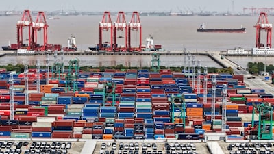 A drone view shows electric vehicles (EV) for export and containers sitting at a port in Shanghai, China. File/Reuters