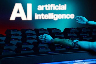 A message reading "AI artificial intelligence", a keyboard, and robot hands are seen in this illustration. File/Reuters