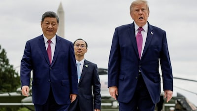 US President Donald Trump and Chinese President Xi Jinping walk back to the White House in Washington, D.C., US, on Thursday. Reuters