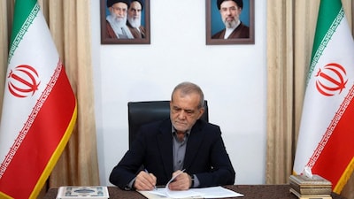 Iranian President Masoud Pezeshkian signs the Memorandum of Understanding with the United States in Tehran on June 18, 2026. (Photo: Iran's Presidential website/WANA/Handout via Reuters) 