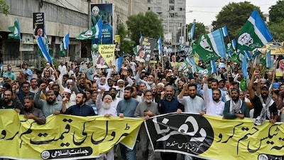 Supporters hold posters of Jamaat-e-Islami party chief Hafiz Naeem Ur Rehman during a protest against increased petroleum levy, rising fuel prices and inflation in Karachi on August 16, 2026. (File image- AFP)
