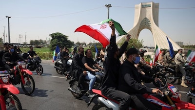 Members of Iranian militia forces (Basij) ride on motorcycles as they participate in a march in Tehran, Iran, September 25, 2026. File Image/WANA via Reuters