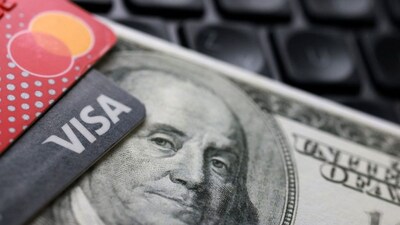 US dollar notes and Visa and Mastercard cards are pictured on a computer keyboard in this illustration. Representational image/Reuters