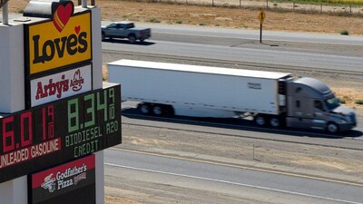 A semi drives past a sign advertising gas and diesel prices along Interstate 5 in Williams, California, US, September 28, 2026. File Image/Reuters