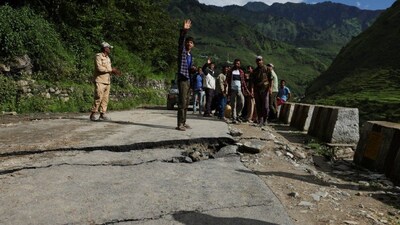 People stand on a damaged road after a landslide in Bhatwadi village, Uttarkashi district, Uttarakhand, on August 7, 2025. A 2025 national-scale assessment, using Yule’s Coefficient model, found that very high landslide susceptibility zones covered 40 per cent of the state. File photo/Reuters