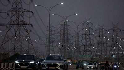 Vehicles move past electricity pylons in Gurugram, India. File/Reuters