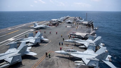 US Navy sailors work on the flight deck of the aircraft carrier USS George Washington as it transits the Arabian Sea. File/Reuters