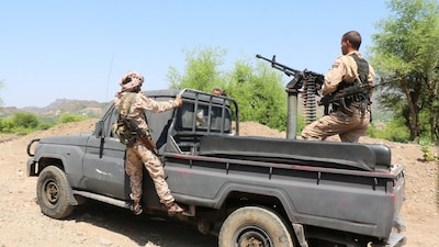 Members of the Saudi-backed Yemeni government forces ride on a military pick-up vehicle as they patrol a road leading to a frontline of clashes with Iran-aligned Houthi fighters, in Taiz province, Yemen. Photo: Reuters