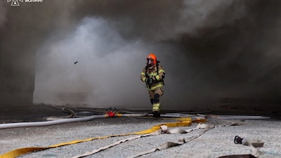 A firefighter works at the site of a food store hit by a Russian drone strike, amid Russia's attack on Ukraine, in Lutsk, Ukraine, on October 14, 2026. Reuters File