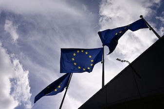 This photograph shows European flags fluttering outside the Berlaymont building. 