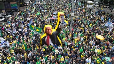 Supporters of Brazilian presidential candidate Flavio Bolsonaro march with an effigy of US President Donald Trump on September 7. AP