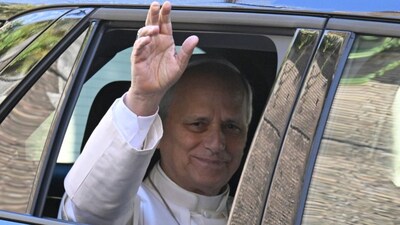 Pope Leo XIV waves from the window of the car as he leaves the Vatican before being admitted to Rome's Gemelli University Hospital for an operation to remove a lump from his lung, in the Vatican. AFP